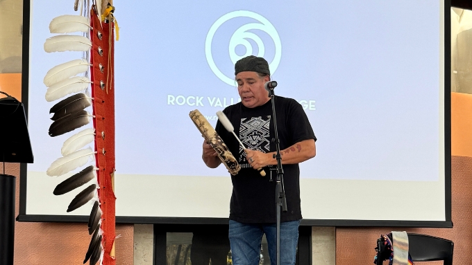 a Native American man plays a hand drum and sings