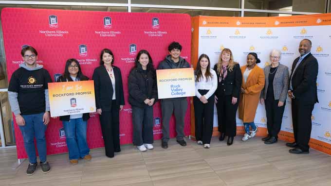 students and college leadership pose in front of NIU and Rockford Promise backdrops