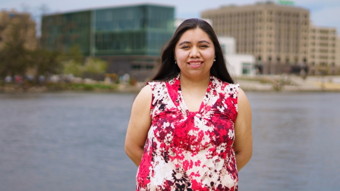 Milca Gonzalez pictured by river in Downtown Rockford