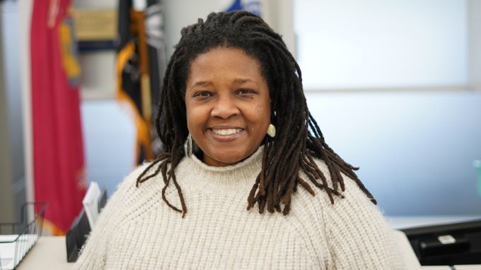 African American woman with dreadlocks wearing a cream color sweater