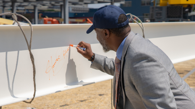 Dr. Howard Spearman, RVC President, signs the final beam at RVC Downtown West.