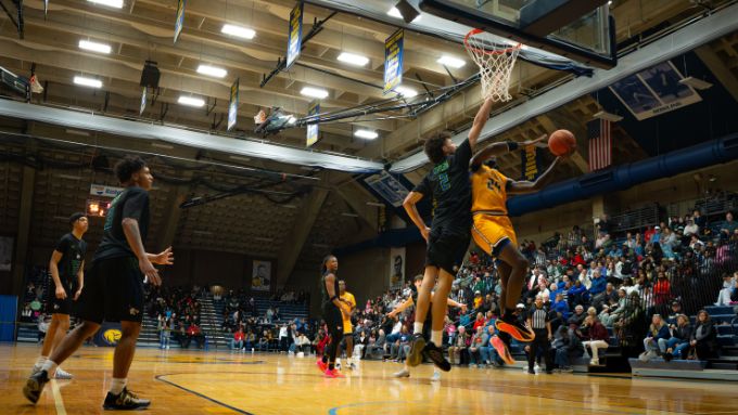 a diverse group of men compete in basketball