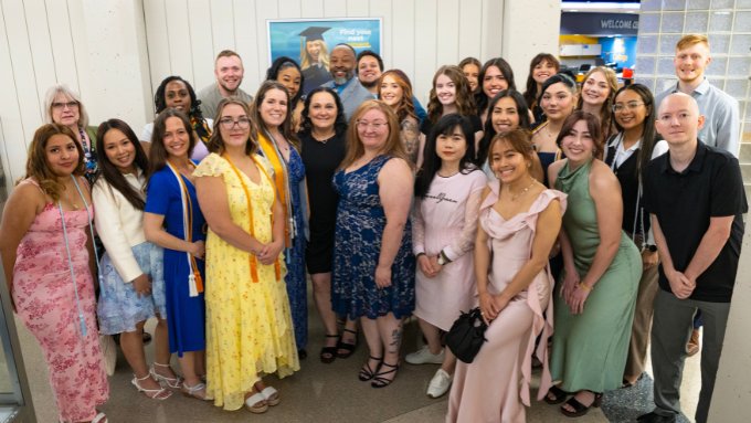 a group of diverse nursing graduates dressed up for their pinning ceremony
